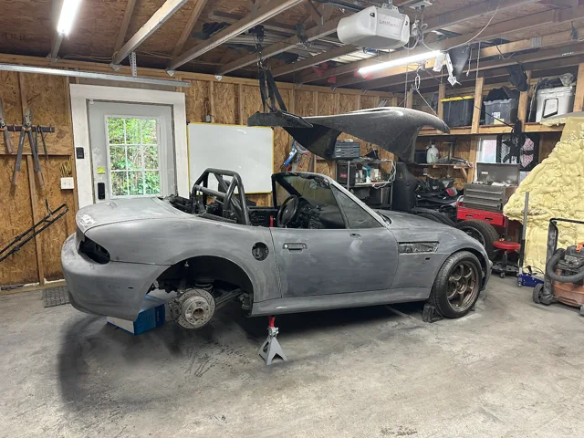The Z3 in the workshop during body preparation, with a rear wheel removed.