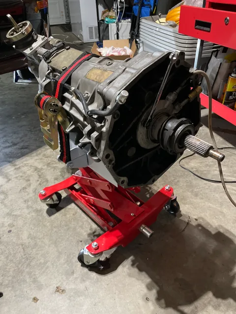 The V8 engine on a red workshop engine stand.