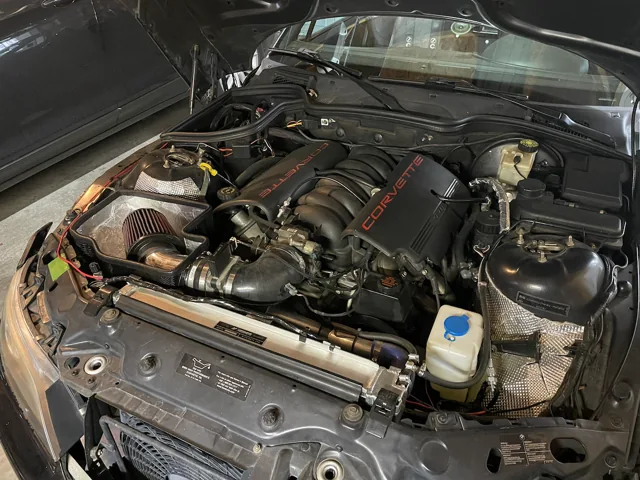 The LS1 V8, intake and supporting hardware in the Z3 engine bay.