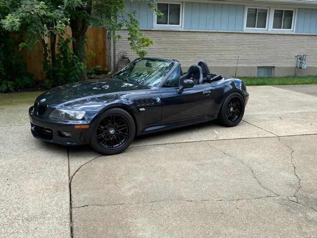 The black Z3 parked outside with the roof off.