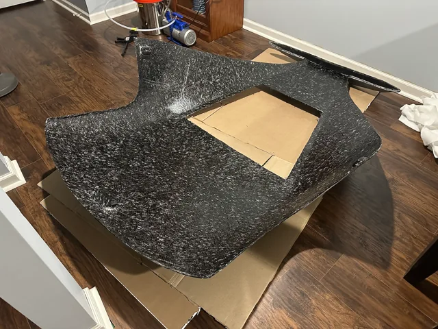 Inside the detached carbon hardtop, showing its structure and rear-window opening.